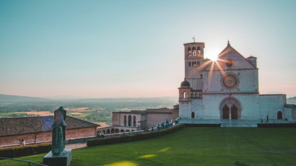 Assisi & St. Francis Heritage Pilgrimage - Assisi hilltop building near green fields