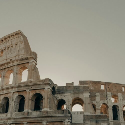 Ancient Rome in a Day — Complete Experience - The Colosseum under a cloudy sky