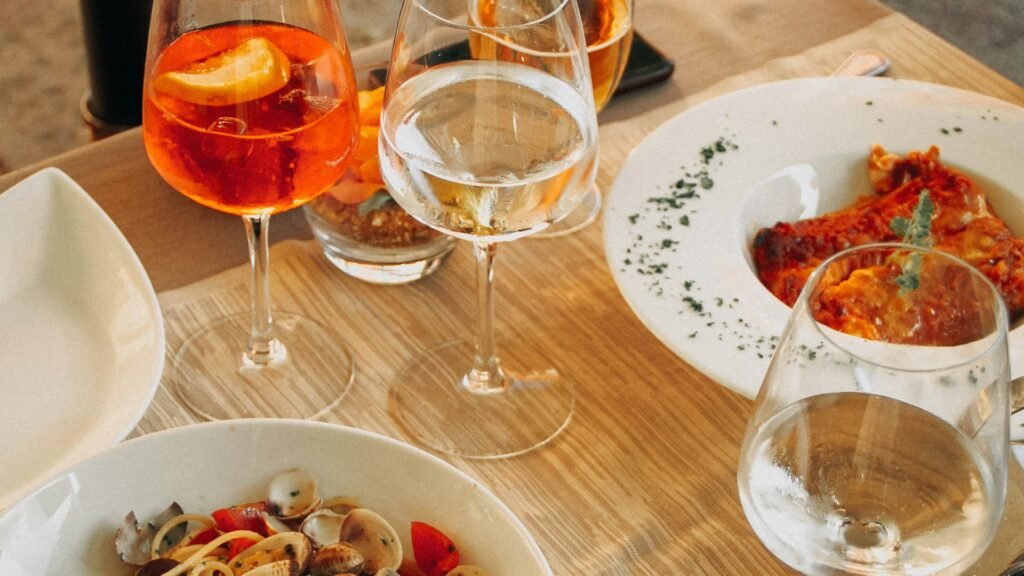 Private Chef Experience in a Roman Apartment - Wine glasses and a multi-course dinner spread
