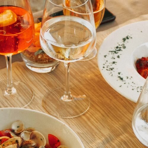 Private Chef Experience in a Roman Apartment - Wine glasses and a multi-course dinner spread